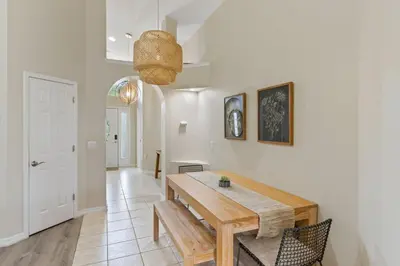 a dining room with a wooden table and chairs at Orlando Family Retreat 4BR, Private Pool and Lake in Kissimmee