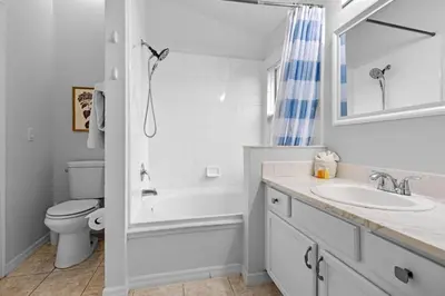 a white bathroom with a sink and a toilet at Orlando Family Retreat 4BR, Private Pool and Lake in Kissimmee