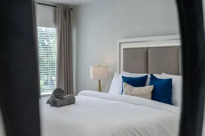 a bedroom with a large bed with a teddy bear on it at Orlando Lake View Entire Home-NearDowntown in Orlando
