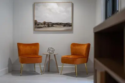 two orange chairs and a table in a room at Orlando Lake View Entire Home-NearDowntown in Orlando