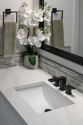 a bathroom sink with a vase of flowers on it at Orlando Lake View Entire Home-NearDowntown in Orlando