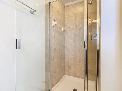 a shower with a glass door in a bathroom at Paradise Palms Disney Retreat 5BR Pool Home in Kissimmee
