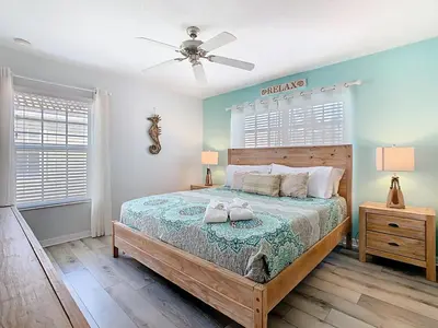 a bedroom with a bed and a ceiling fan at Paradise Palms Disney Retreat 5BR Pool Home in Kissimmee