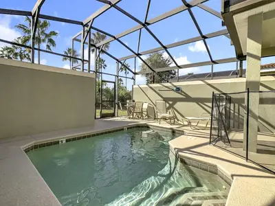 an indoor swimming pool with a glass roof at Paradise Palms Disney Retreat 5BR Pool Home in Kissimmee