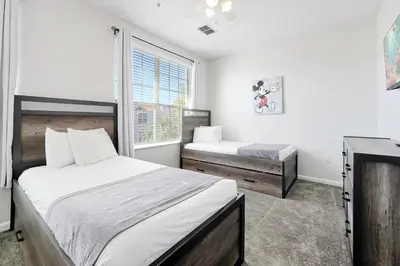 a bedroom with two beds and a window at Epic Universe Vacation Townhome, Vista Cay - 4035 in Orlando