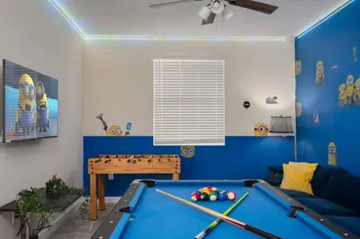 a playroom with a pool table and blue walls at Heated Pool Game Room Waterpark 9MI to Disney in Kissimmee