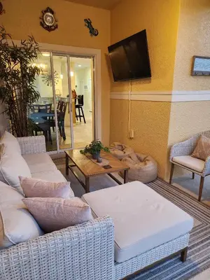 a living room with couches and a flat screen tv at Villa Coco in Kissimmee