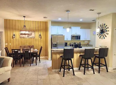 a kitchen and dining room with a table and chairs at Villa Coco in Kissimmee