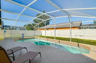 an empty swimming pool with a large glass canopy at 10 Mi to Animal Kingdom Clermont Home with Pool! in Orlando