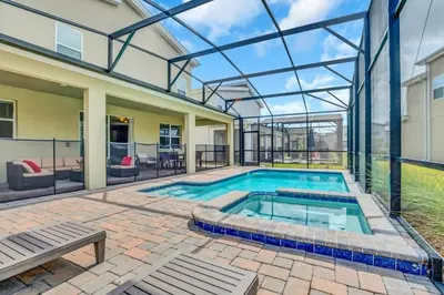 a swimming pool in a house with a glass ceiling at Storey Lake Casa 9Q c Piscina, Cinema e Game Room in Kissimmee