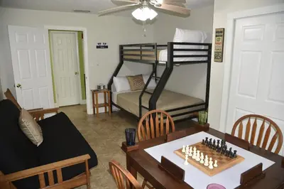 a living room with a table and a bunk bed at Perfecto Mundo 2, Orlando Area 4BR-2B-Outdoor Pool-Jacuzzi-Billiard in Orlando
