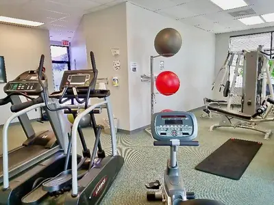 a gym with two tread machines in a room at Sea World Orlando Apt - Minutes From Parks in Orlando