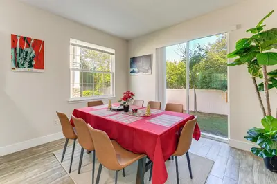 a dining room with a red table and chairs at 5 Mi to Old Town Kissimmee! Family Escape with Perks in Kissimmee