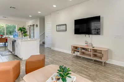 a living room with a flat screen tv on the wall at 5 Mi to Old Town Kissimmee! Family Escape with Perks in Kissimmee