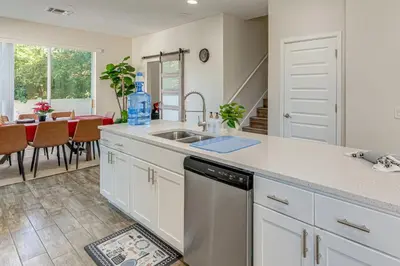 a kitchen with a sink and a dishwasher at 5 Mi to Old Town Kissimmee! Family Escape with Perks in Kissimmee