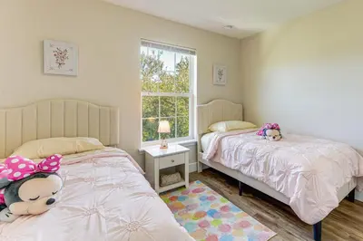 a bedroom with two beds and a window at 5 Mi to Old Town Kissimmee! Family Escape with Perks in Kissimmee