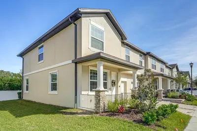 a house with a landscaping in front of it at 5 Mi to Old Town Kissimmee! Family Escape with Perks in Kissimmee
