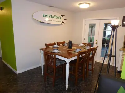 a table with chairs and a sign on a wall at Perfecto Mundo 4, Orlando Area 4BR-2BA Jacuzzi-Billiard-Ping Pong-City Pool in Orlando
