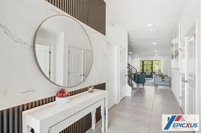 a hallway with a mirror and a white sink at The Epic Venice Paradiso Grande Orlando Florida in Orlando