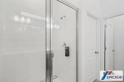 a shower with a glass door in a bathroom at The Epic Venice Paradiso Grande Orlando Florida in Orlando