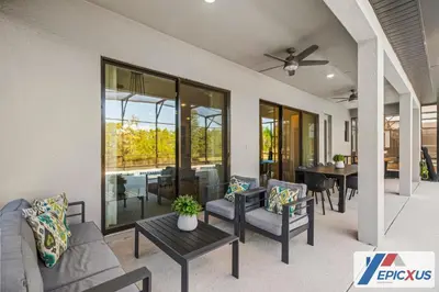 a living room with couches and a table at The Epic Venice Paradiso Grande Orlando Florida in Orlando