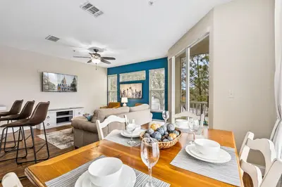 a dining room and living room with a table and chairs at 8805 Dunes Court Unit 5-202 in Kissimmee