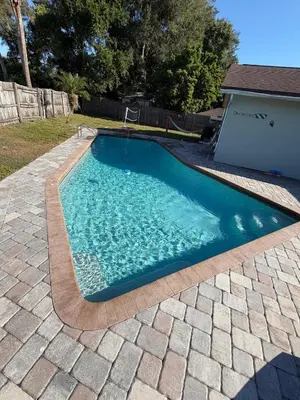 a swimming pool in a yard with a driveway at Perfecto Mundo 1, Orlando Area 5BR-2BA Outdoor Pool, Ping Pong, Billiard in Orlando