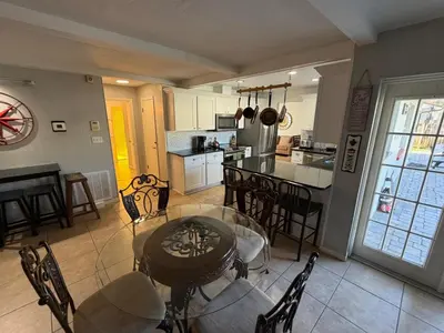 a kitchen and dining room with a table and chairs at Perfecto Mundo 1, Orlando Area 5BR-2BA Outdoor Pool, Ping Pong, Billiard in Orlando