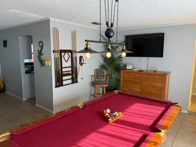 a living room with a large pool table at Perfecto Mundo 1, Orlando Area 5BR-2BA Outdoor Pool, Ping Pong, Billiard in Orlando
