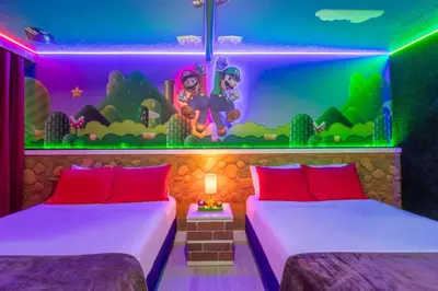 a room with two beds and a wall with a mural at Modern Unit w Themed Room, Full Kitchen and Prime Location in Orlando