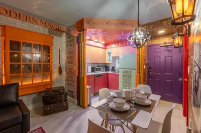 a kitchen with colorful doors and a table and chairs at Wizard Themed Suite near Universal and Epic in Orlando