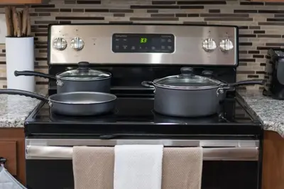 two pots on a stove in a kitchen at Jacuzzi and Games Close to Dwtn Disney and Parks in Orlando