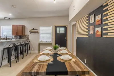 a dining room with a table and a kitchen at Jacuzzi and Games Close to Dwtn Disney and Parks in Orlando
