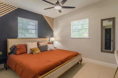 a bedroom with a bed and a ceiling fan at Jacuzzi and Games Close to Dwtn Disney and Parks in Orlando