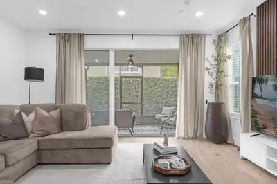a living room with a couch and a television at Modern Winter Park Townhome in Prime Location in Orlando