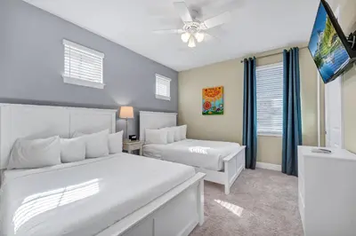a bedroom with two beds and a flat screen tv at Home With Theme Room, Private Pool & Game Room Near Disney With Waterpark And Resort Access At Encore Resort Reunion - 471La in Orlando