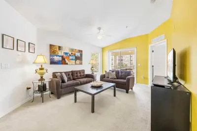a living room with two couches and a tv at 2730 Club Cortile Circle Apt. B in Kissimmee