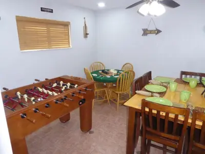 a dining room with a table and a game board at Perfecto Mundo 7, Orlando Area 6BR-2MB-3BR Indoor Pool, Ping Pong, Jacuzzi, Disney in Orlando