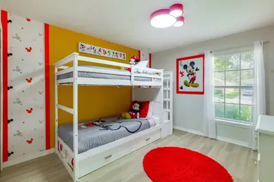 a childs bedroom with a bunk bed and a red rug at Peaceful Clermont Gem with Pool, 9 Mi to Disney! in Orlando