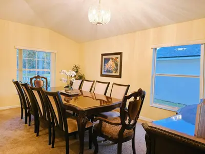 a dining room with a table and chairs at Luxury Family Villa with Pool Near Disney Parks in Kissimmee