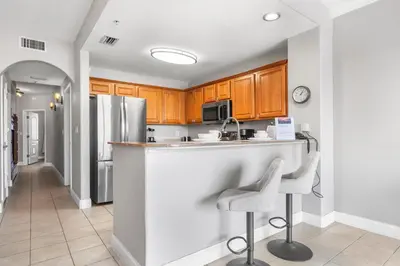 a kitchen with a counter and two stools at 13415 Blue Heron Beach Dr 1-708 in Orlando