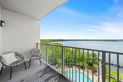 a balcony with chairs and a view of the water at 13415 Blue Heron Beach Dr 1-708 in Orlando