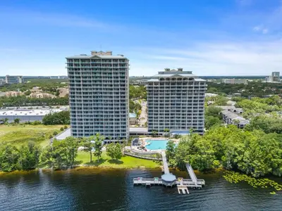 an aerial view of two tall buildings on the water at 13415 Blue Heron Beach Dr 1-708 in Orlando