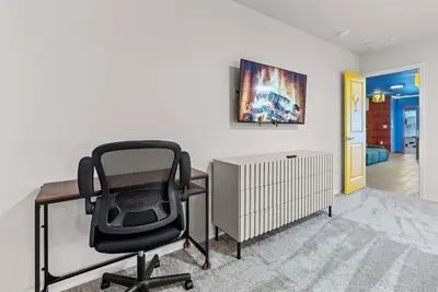 a office with a black chair and a desk at Brand New 05 Bedrooms At Windsor Cay in Orlando