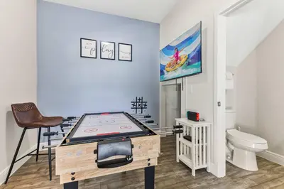 a room with a ping pong table and a toilet at 4461 Summer Flowers Pl in Kissimmee