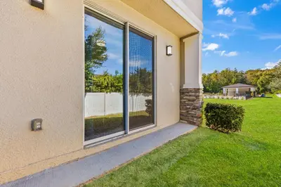 a large window of a house with a yard at 4461 Summer Flowers Pl in Kissimmee