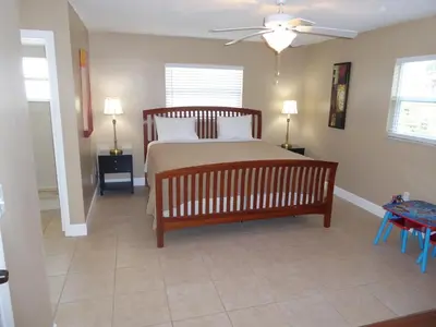 a bedroom with a bed and a ceiling fan at Perfecto Mundo 6, Orlando Area 4BR-2MB-3Bath Huge Pool, Ping Pong, Billiard, Disney Universal in Orlando