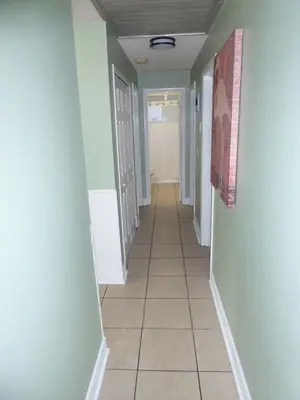 a hallway with blue walls and a tile floor at Perfecto Mundo 6, Orlando Area 4BR-2MB-3Bath Huge Pool, Ping Pong, Billiard, Disney Universal in Orlando