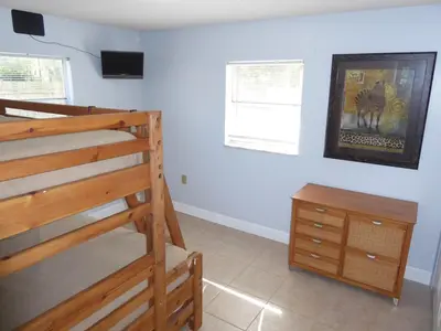a bedroom with a bunk bed and a dresser at Perfecto Mundo 6, Orlando Area 4BR-2MB-3Bath Huge Pool, Ping Pong, Billiard, Disney Universal in Orlando