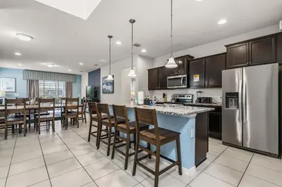 a kitchen and dining room with stainless steel appliances at Lavish Villa W Private Pool And Spa And Free Resort in Orlando